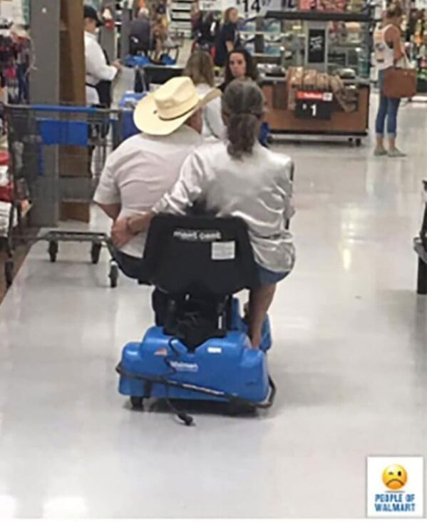 people of walmart - man and woman riding on motorized shopping cart together