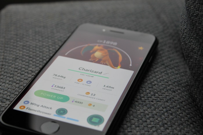 Turned-on Iphone Displaying Pokemon Go Charizard Application