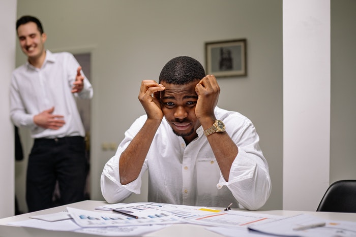 Person Laughing at a Man in White Top