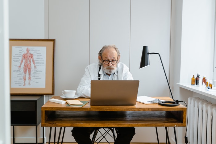 Man in White Dress Shirt Using Macbook