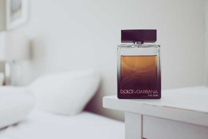 Dolce & Gabbana The One fragrance bottle on white wooden table