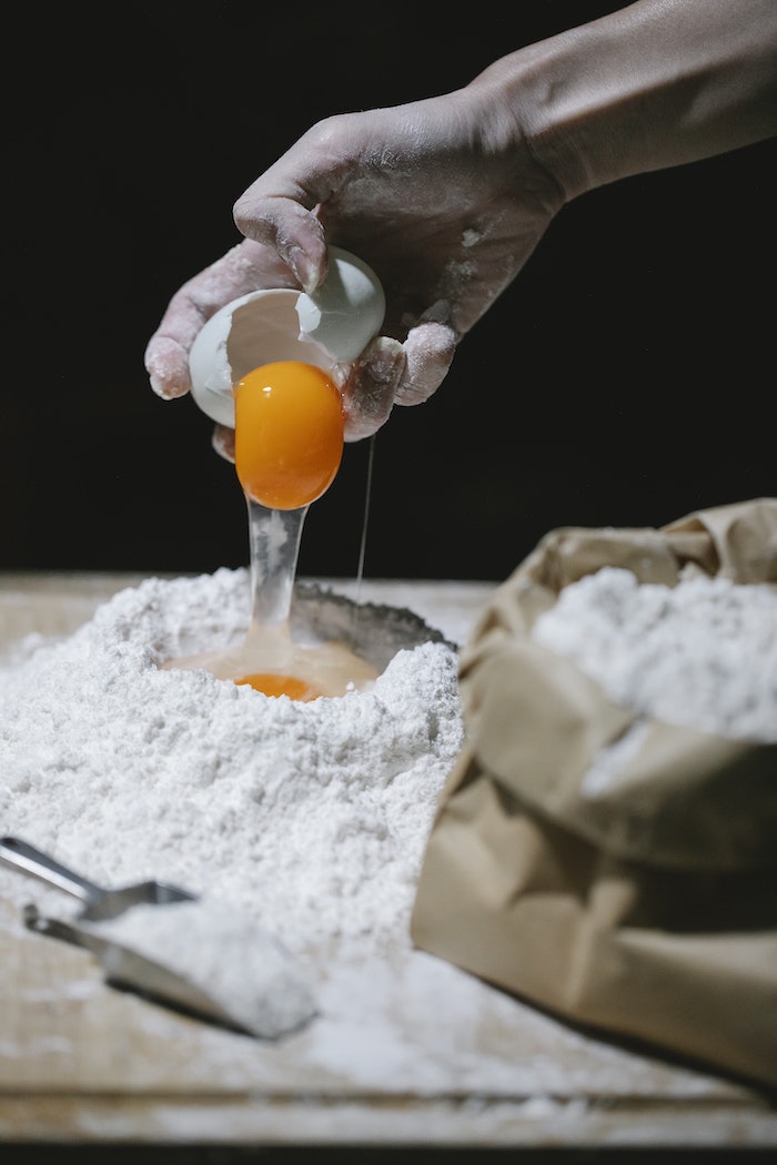 Adding of Egg on a Heap Flour