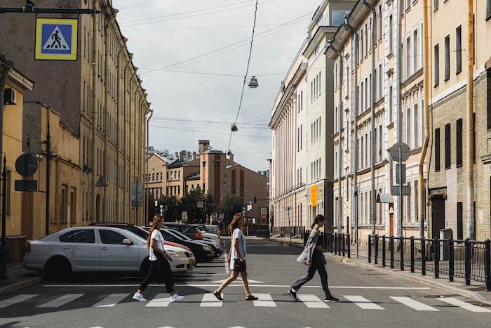 people walking on sidewalk near buildings during daytime