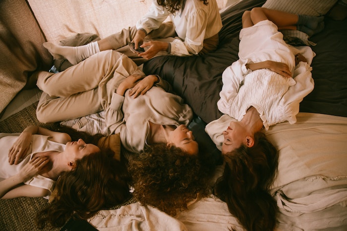 Group of Teenage Girls Laying on Bed