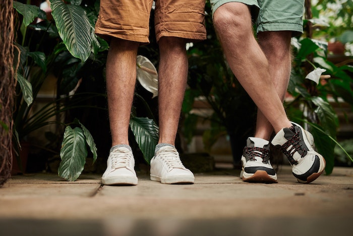 Two People Standing Side by Side in Front of Plants