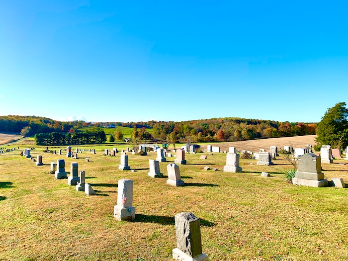 white cross on green grass field during daytime