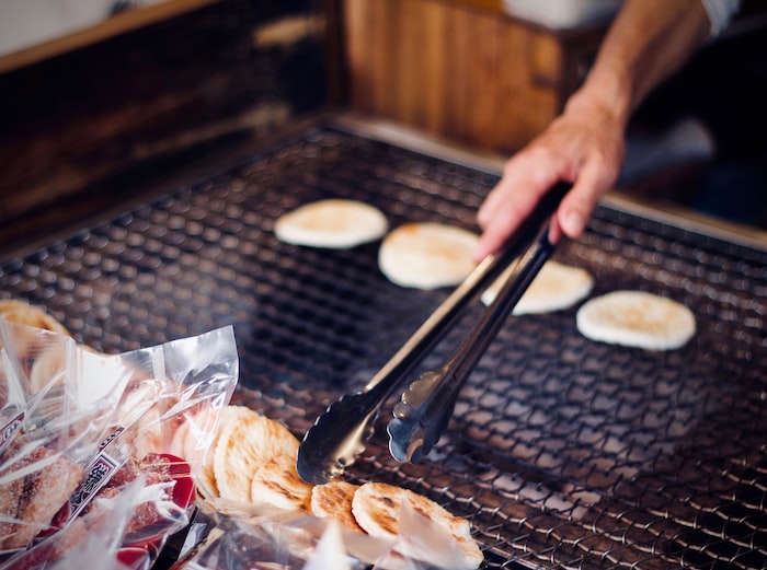 person holding tong while grilling