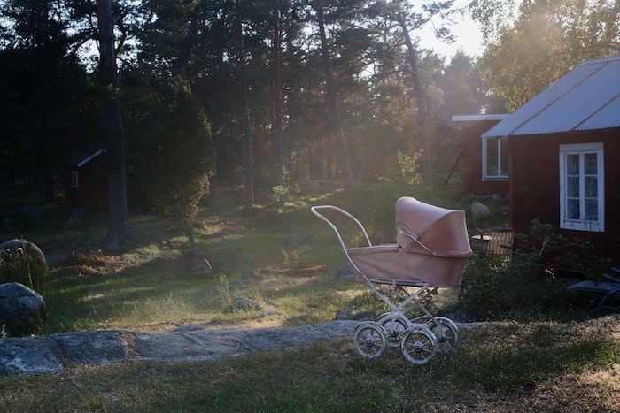 brown stroller near house