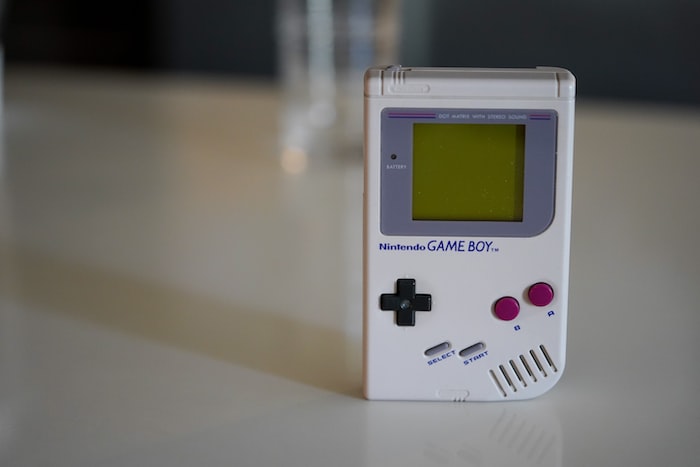 white nintendo game boy on white table