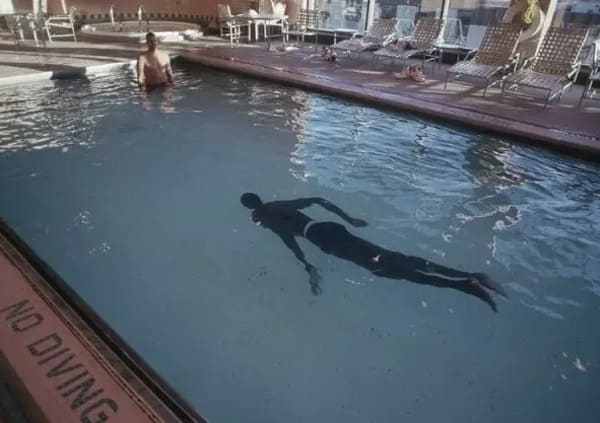 interesting pics - manute bol swimming in pool